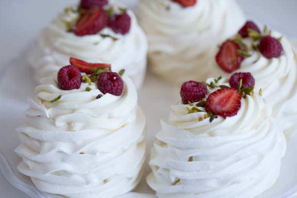 istock Pavlova cakes with cream and fresh summer berries 1020120156