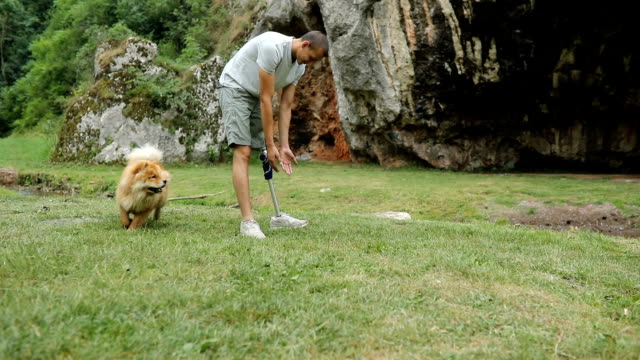 Man playing with dog in nature