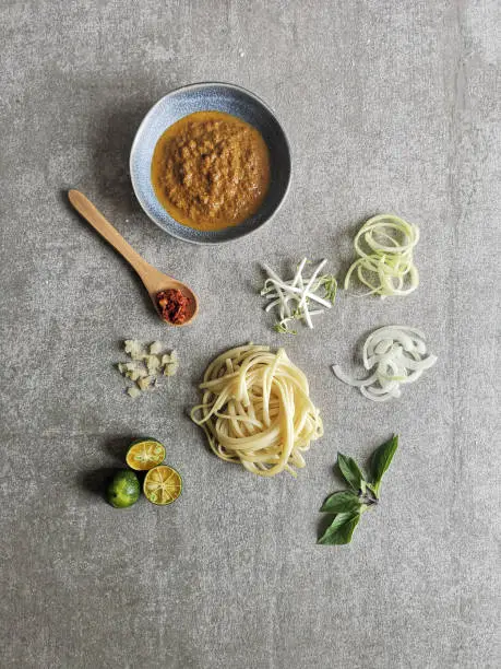 Johor laksa ingredients spread out is a Malaysian southern state dish that uses traditional ingredients fused with western noodles like skinny fettuccine