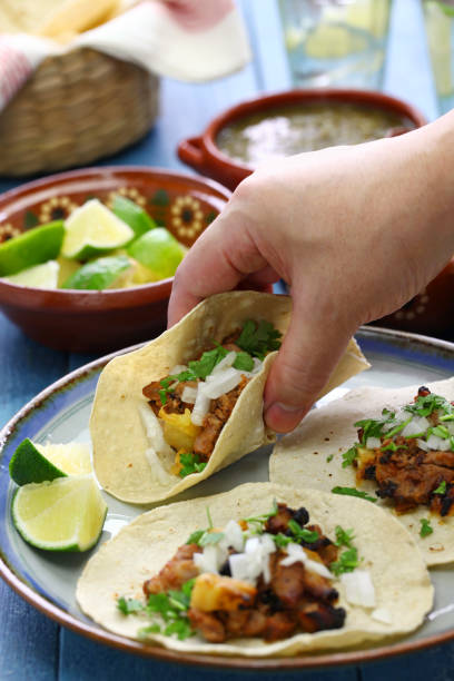 istock tacos al pastor, mexican food, eat with hands 1020146128