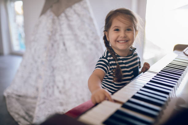 istock Cheerful smiling toddler playing a piano at home 1020154338
