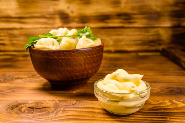 istock Fresh dumplings in ceramic bowl on wooden table 1020157870
