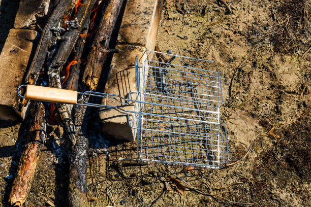 istock Barbecue grill near the campfire in a forest 1020157954