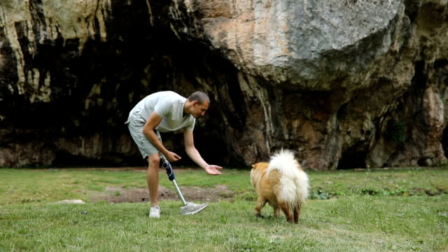 Man playing with pet in nature