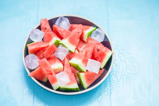 istock slices of watermelon in a plate with ice on a blue background 1020158452