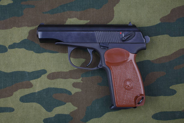 istock 9mm russian handgun on russian camouflage uniform 1020163354