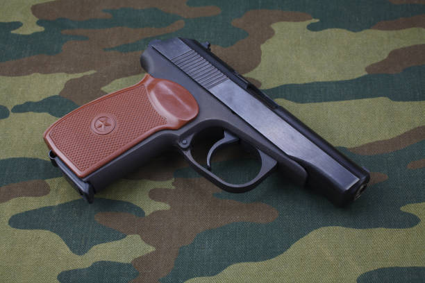 istock 9mm russian handgun on russian camouflage uniform 1020163480