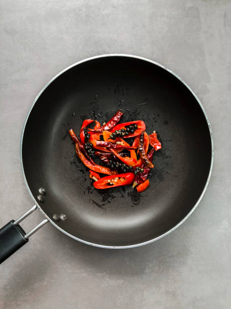 Fried spicy ingredients in the black pan.