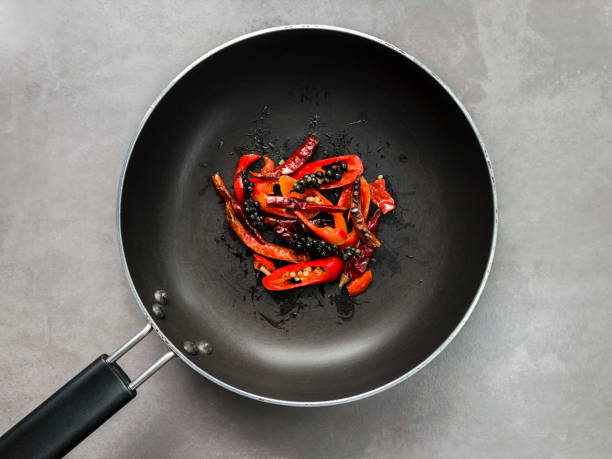 Fried spicy ingredients in the black pan.