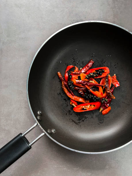 Fried spicy ingredients in the black pan.