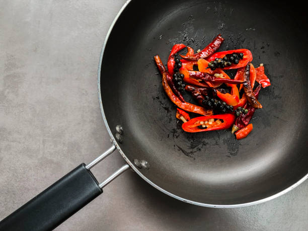 Fried spicy ingredients in the black pan.