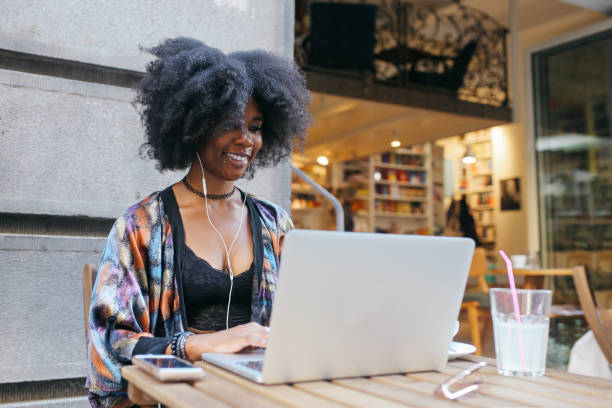 istock Young woman sitting in a cafe, having a drink while finishing up her online work 1020191756