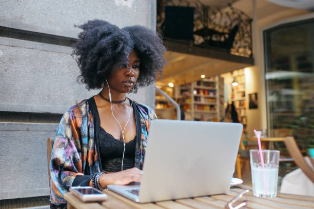istock Young woman sitting in a cafe, having a drink while finishing up her online work 1020191768