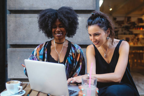 istock Two young women together in a cafe, looking at stuff at her laptop 1020191780