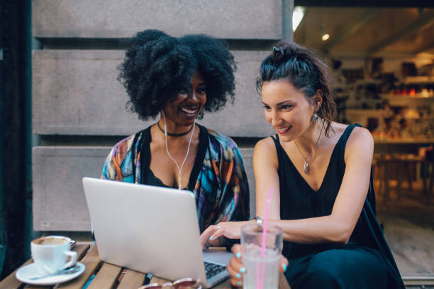 istock Two young women together in a cafe, looking at stuff at her laptop 1020191782