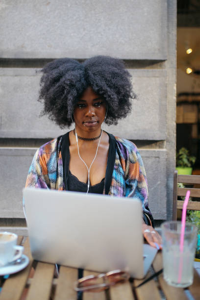 istock Young digital nomad woman sitting in a cafe, relaxing, doing freelance work on a laptop 1020191802