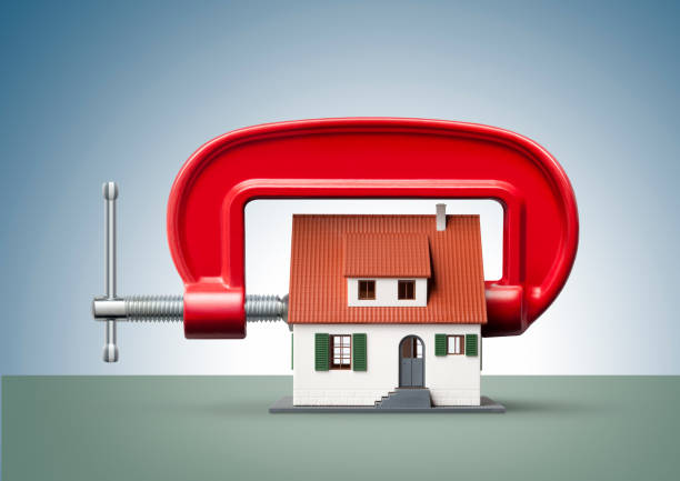 House being squeezed in a g clamp Clamp squeezing model house.. c clamp photos stock pictures, royalty-free photos & images