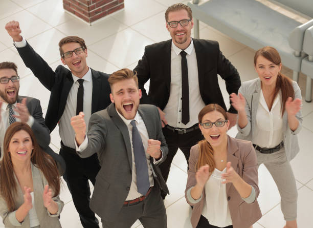 istock top view.happy business team standing together and looking at the camera 1020211364