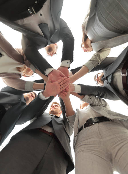 istock bottom view. business team showing unity with their hands together 1020216726