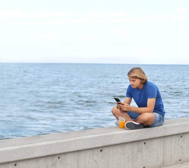 istock Teenage boy typing text message.Using smart phone. 1020224496