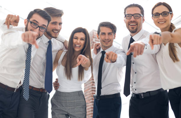 istock close up.a successful business team pointing to you 1020227452