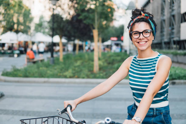 istock Woman sitting on a bicycle and smiling 1020227514