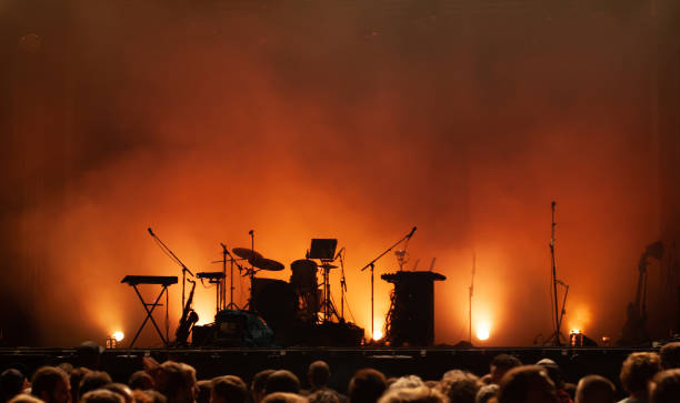 empty concert stage on music festival, instruments silhouettes empty concert stage on music festival, instruments silhouettes, microphones drums guitars and crowd of people drum percussion instrument stock pictures, royalty-free photos & images