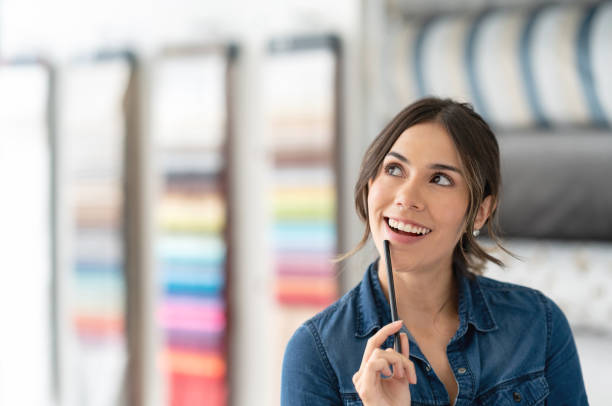 Thoughtful interior designer choosing fabrics at a textile shop