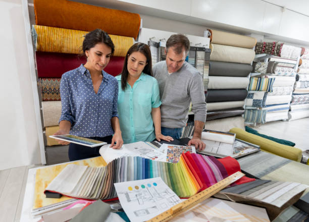 istock Interior designer with a couple choosing fabrics for a house project 1020230036