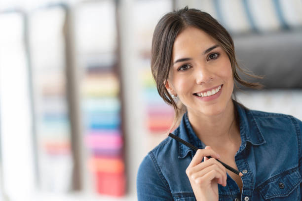 istock Happy interior designer choosing fabrics at a textile shop 1020230068