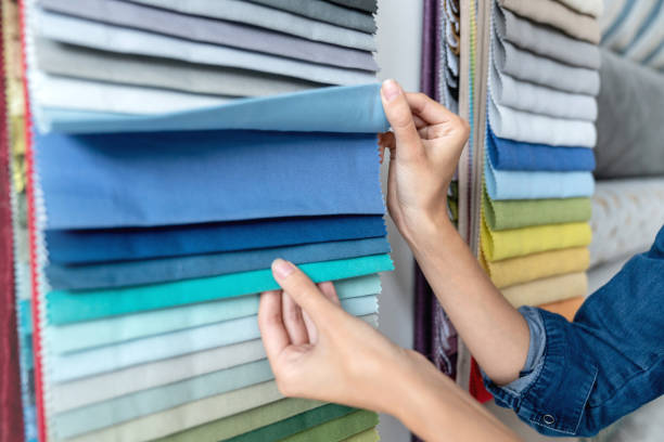istock Close-up on a woman choosing fabrics at a textile shop 1020230216