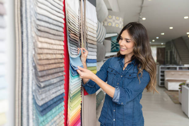 istock Happy woman choosing fabrics at a textile shop 1020230234