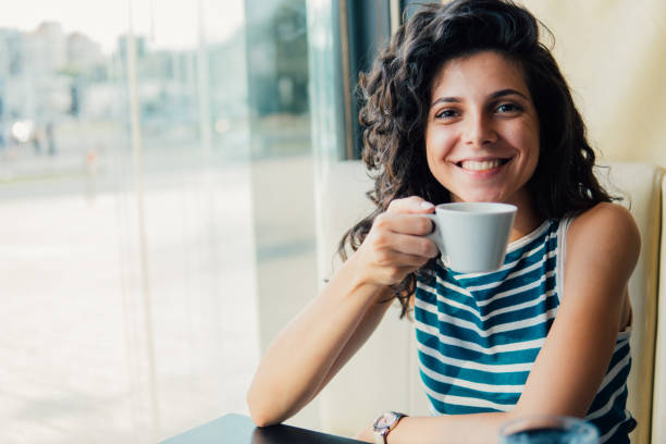 istock Happy young woman having a cup of coffee 1020230742