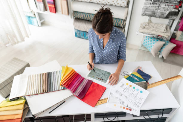 istock Interior designer working on a house project and choosing fabrics at a textile shop 1020233294
