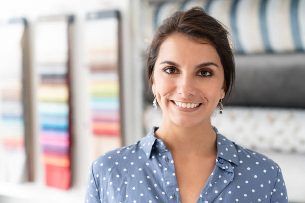 istock Happy woman choosing fabrics at a textile shop 1020233316