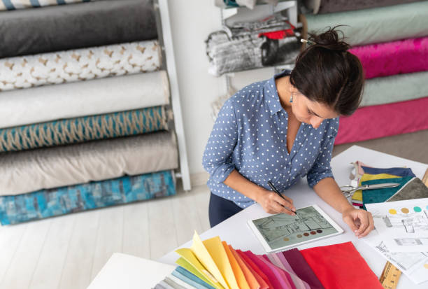 istock Interior designer working on a house project and choosing fabrics at a textile shop 1020233366