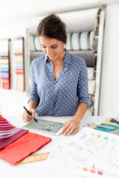 istock Woman working on a house project and choosing fabrics at a textile shop 1020233368