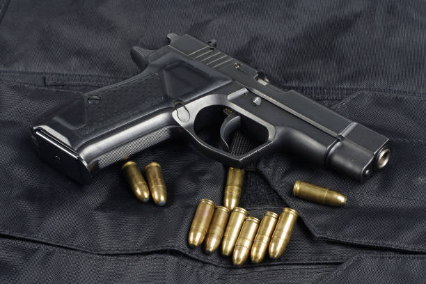 istock police handgun on black uniform background 1020236446