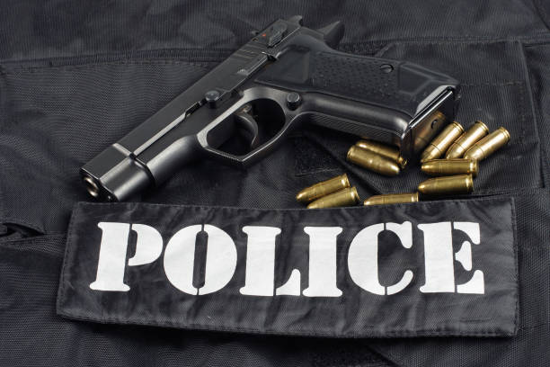 istock police handgun on black uniform background 1020236492