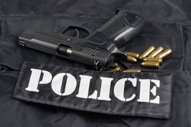 istock police handgun on black uniform background 1020236508