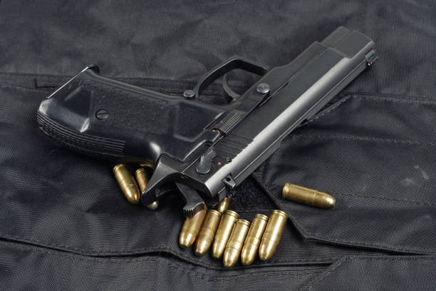 istock police handgun on black uniform background 1020236538