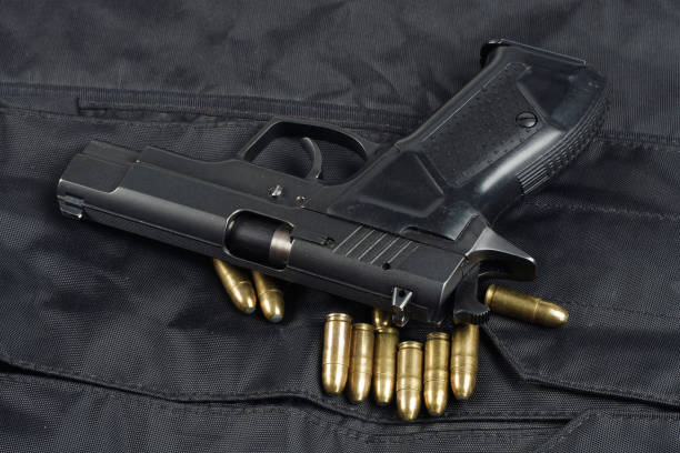 istock police handgun on black uniform background 1020238560