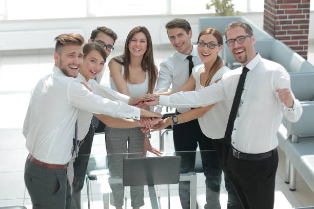 istock smiling business team showing their unity 1020238650