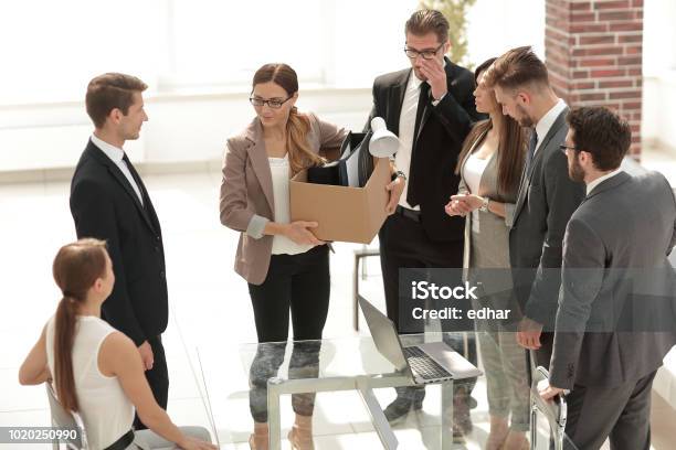 Fired Employee With Personal Things Standing In The Office Stock Photo - Download Image Now