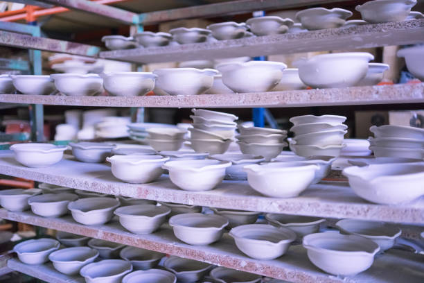 istock Ceramic dishes in working process. Creating ceramic pieces. Tradicional ceramic factory in spain. man working with traditional potter's wheel 1020251068