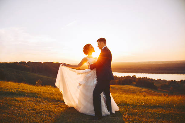istock Bride and groom embrace in nature during sunset 1020255810
