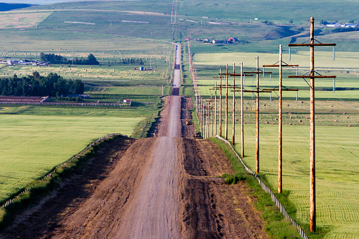 A country road in a rural landscape in Pincher Creek, Alberta, Canada.