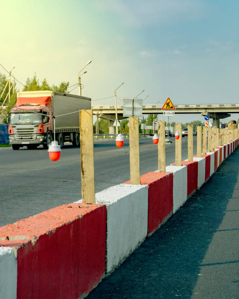 Highway repair. Red safety lights installed on concrete barriers. stock photo