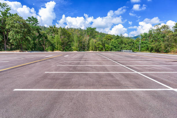 istock Empty parking lot with forest and beautiful blue sky. 1020296902