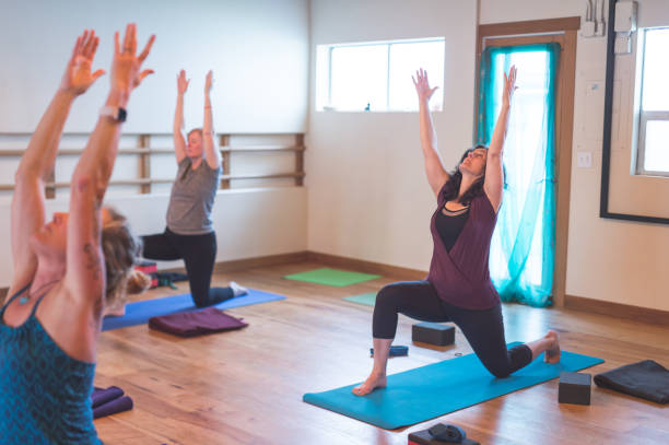 istock Group of women doing yoga together in a modern studio 1020299902